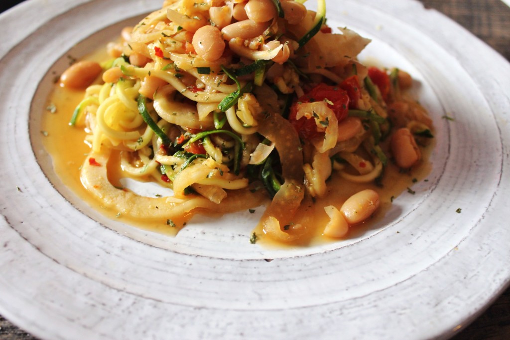 closeup shot of zucchini noodles with braised fennel, tomato and beans!