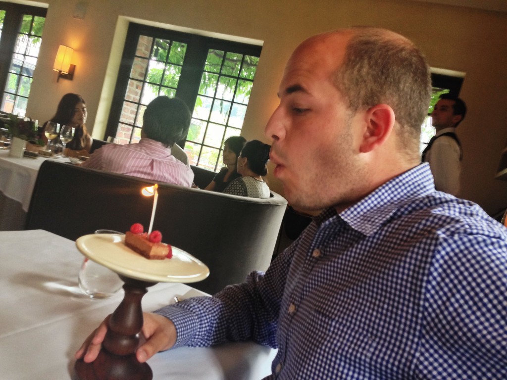 brian blowing out birthday candle at blue hill stone barns